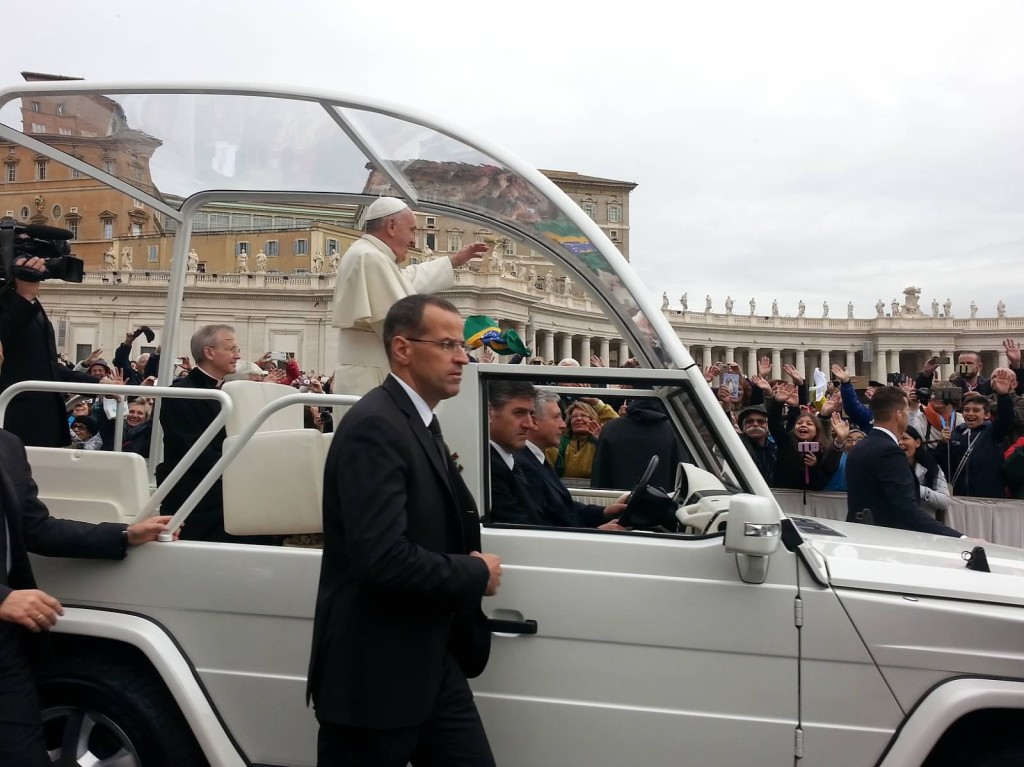 Pope Francis greeting the people in his Pope-mobile