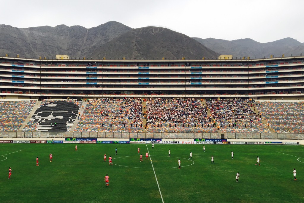 Watching a soccer match at Estadio Monumental in Lima, Peru