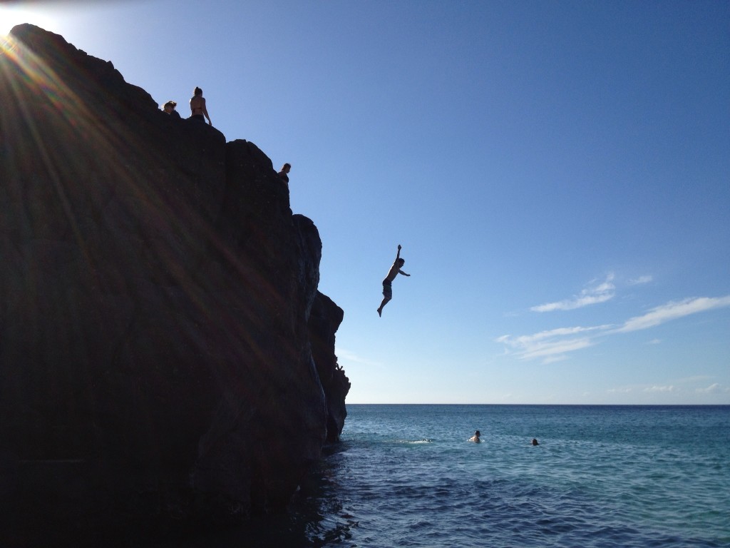 Leaping off jump rock in Waimea Bay