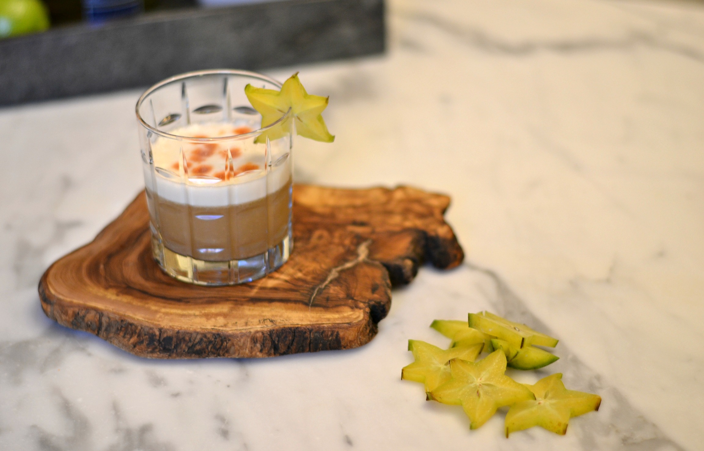 Pisco sour cocktail garnished with a slice of starfruit