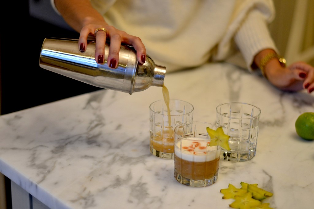 Pouring a pisco sour cocktail