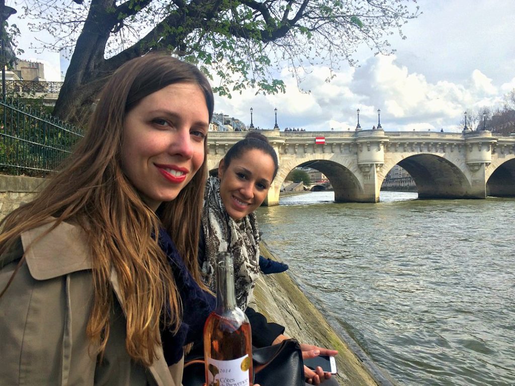 sitting-with-a-friend-along-the-river-seine-in-paris-france