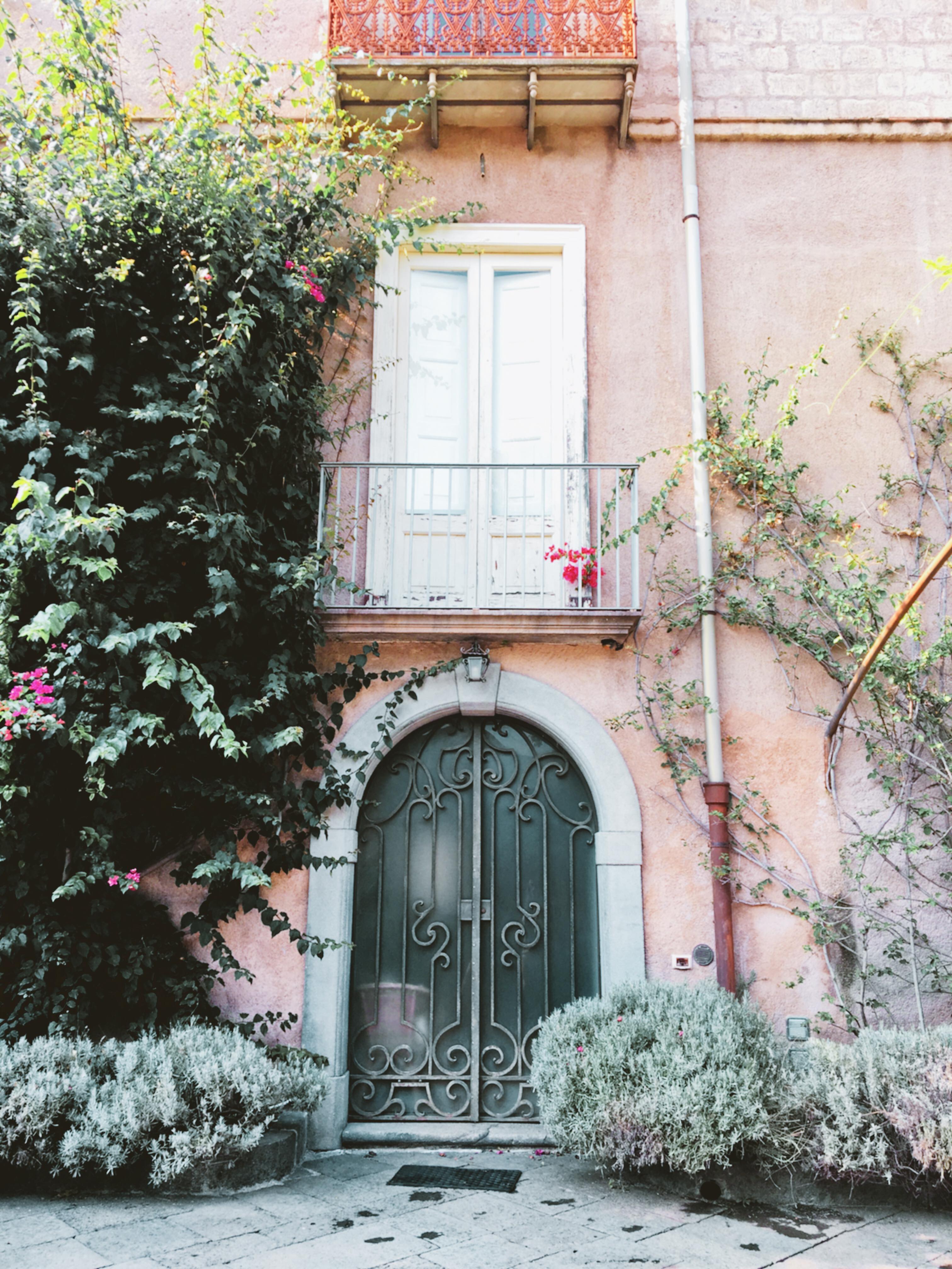 Flowers hanging over a door in Lauro, Italy