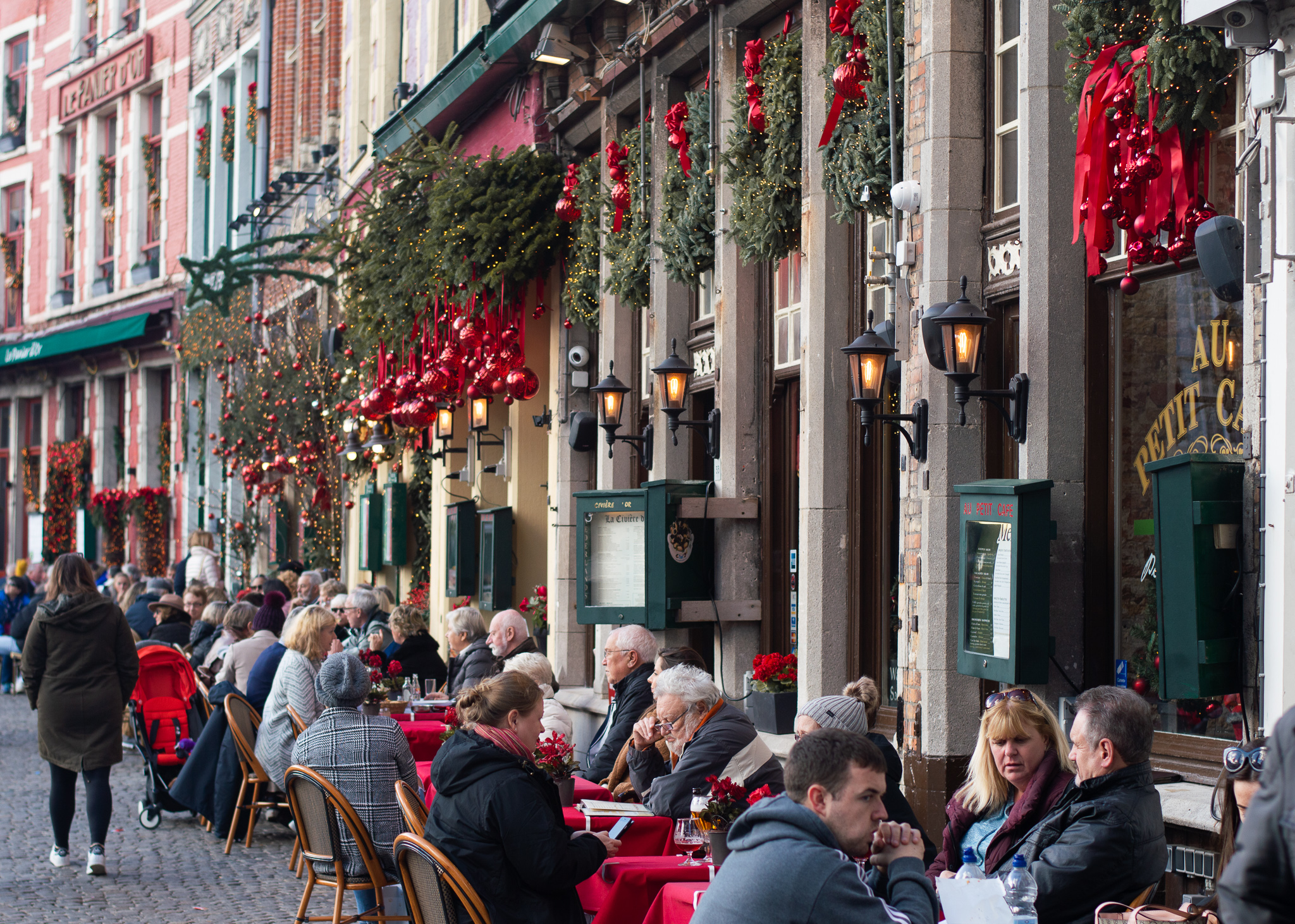Visitors dining at Markt in Bruges, Belgium